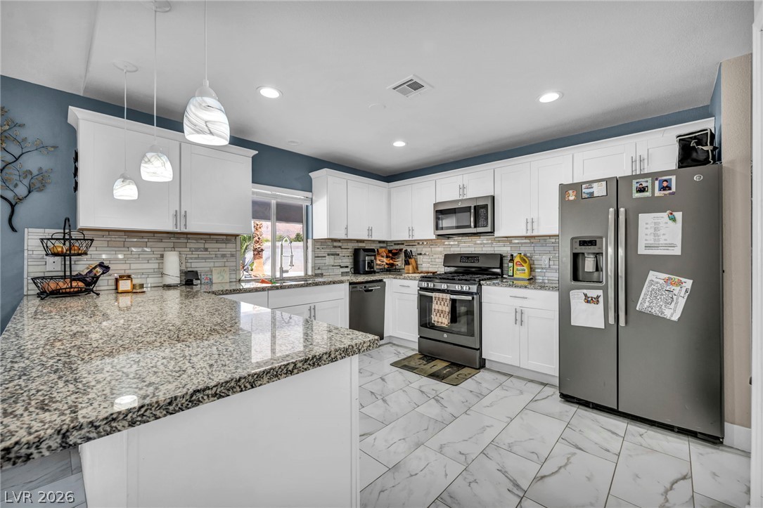 5882 Rio Tinto Way Las Vegas, NV 89110 - Photo 27 of 56 Granite counters and stainless appliances define this well-appointed kitchen.