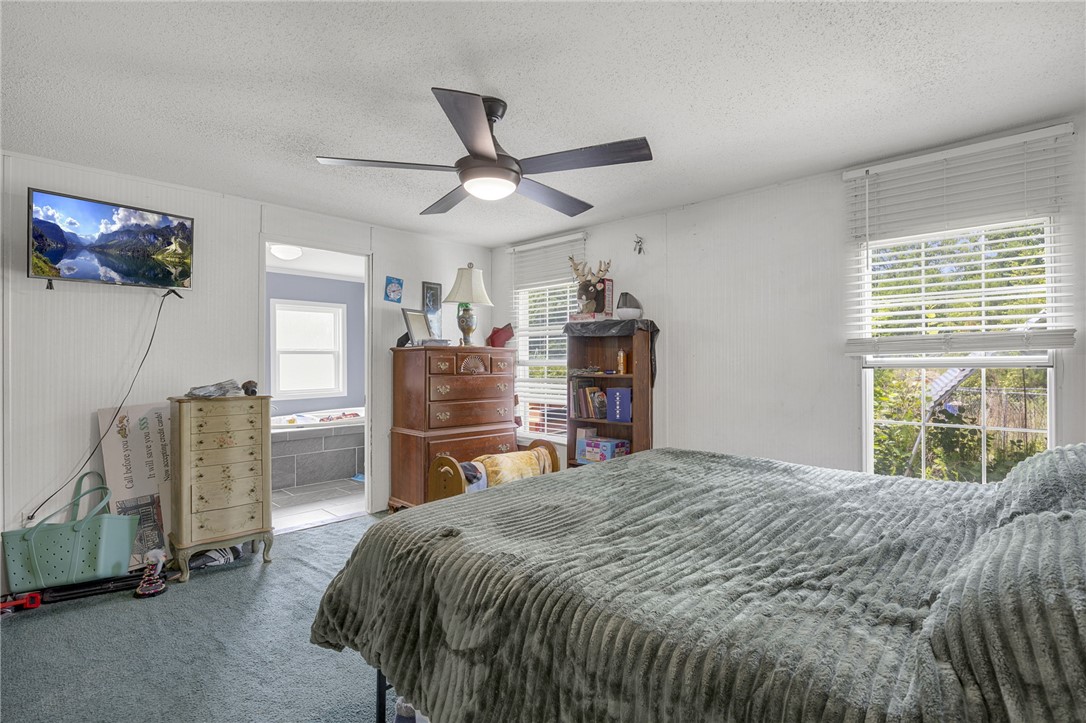 1549 Bethany Church Road Belton, SC 29627 - Photo 24 of 36 A restful bedroom offers direct access to a private bath, perfect for peaceful mornings.