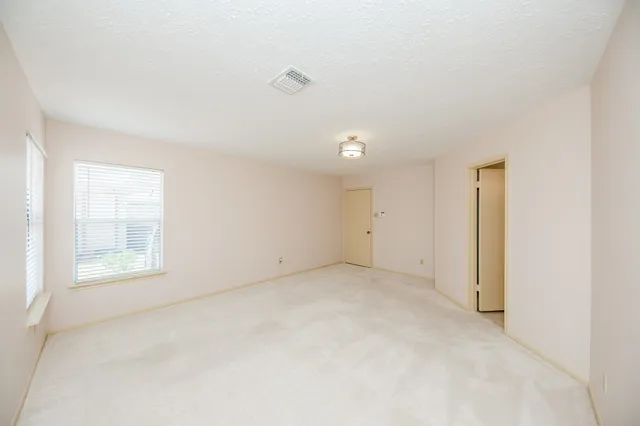 an empty room with a empty space and windows