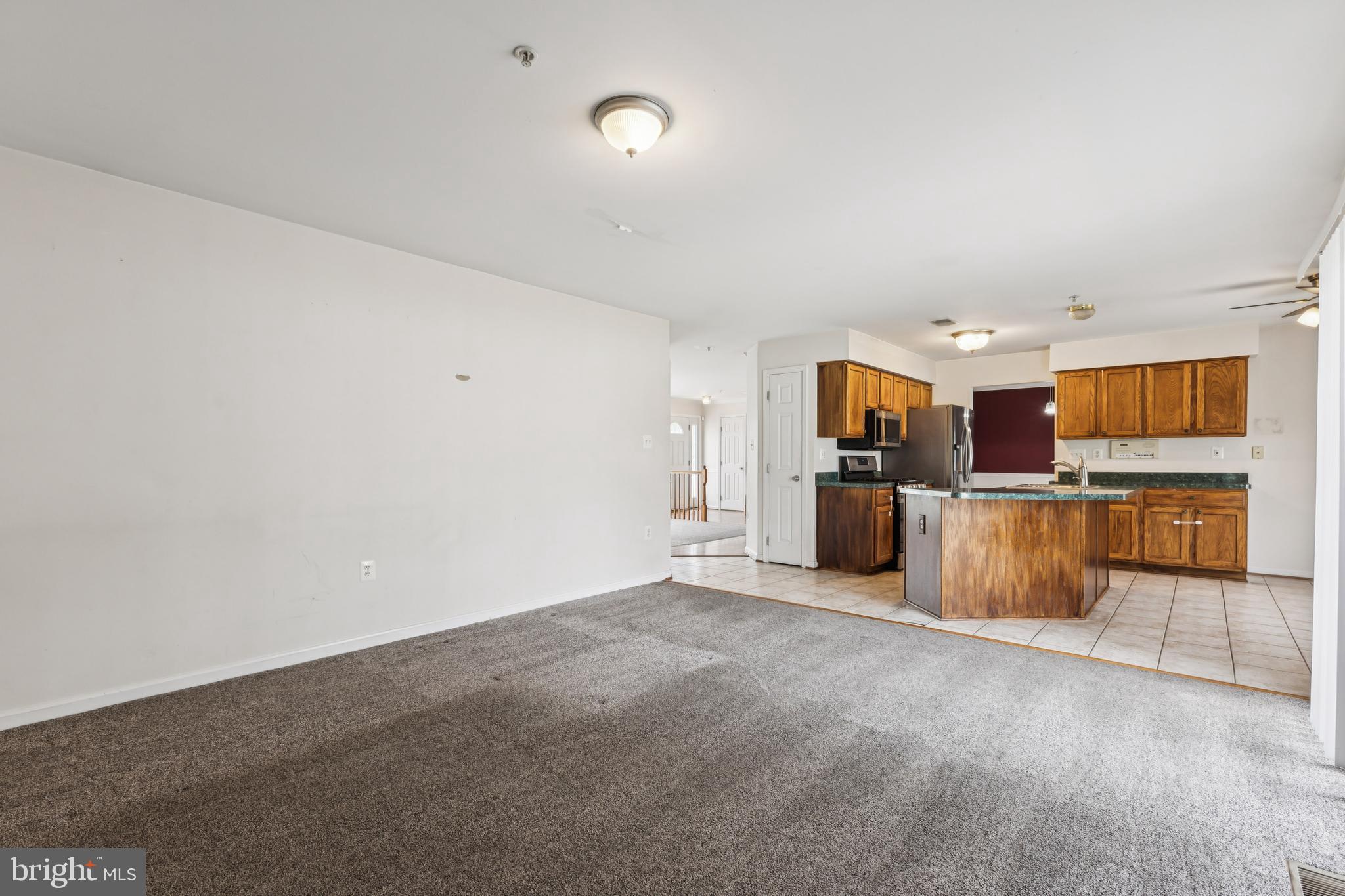8305 Joan Place Clinton, MD 20735 - Photo 14 of 40 a view of a kitchen with furniture and an empty room