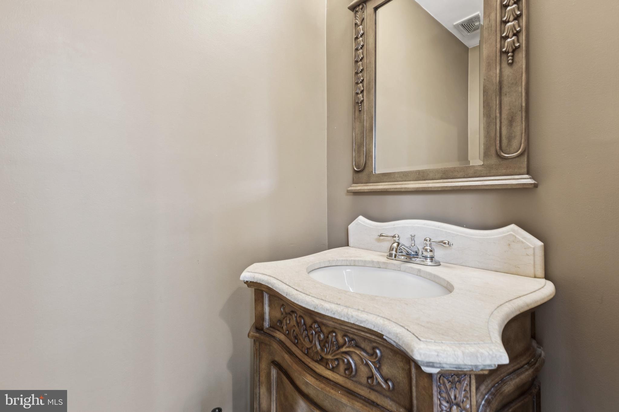 8305 Joan Place Clinton, MD 20735 - Photo 28 of 40 a bathroom with a sink and a mirror