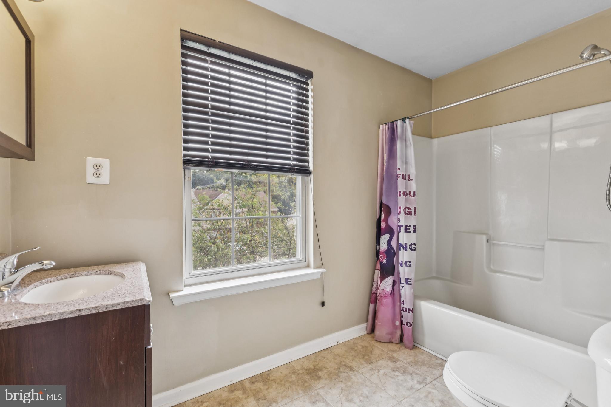 8305 Joan Place Clinton, MD 20735 - Photo 29 of 40 a bathroom with a granite countertop sink toilet and shower