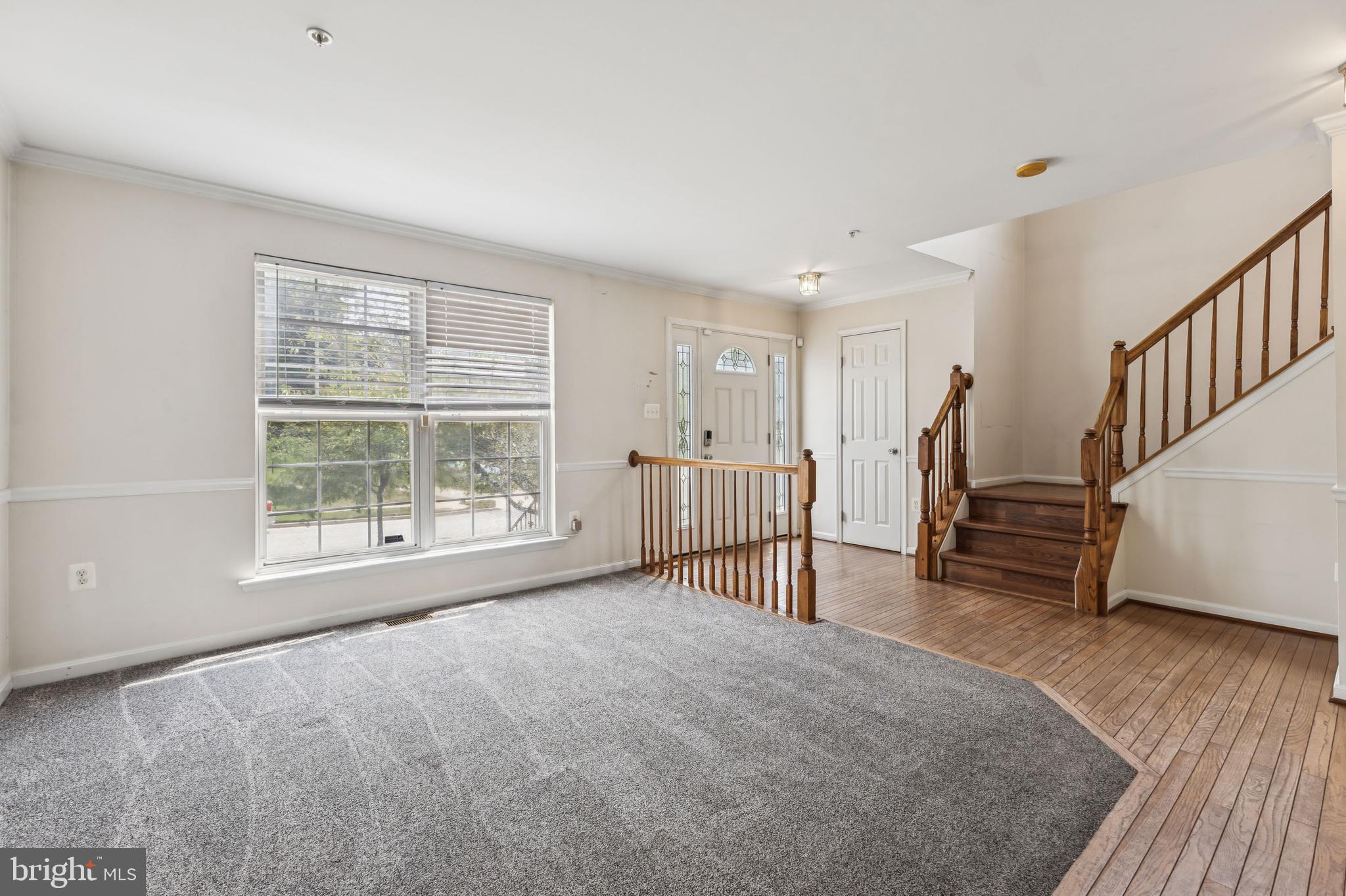 8305 Joan Place Clinton, MD 20735 - Photo 7 of 40 a view of an empty room with wooden floor and a window