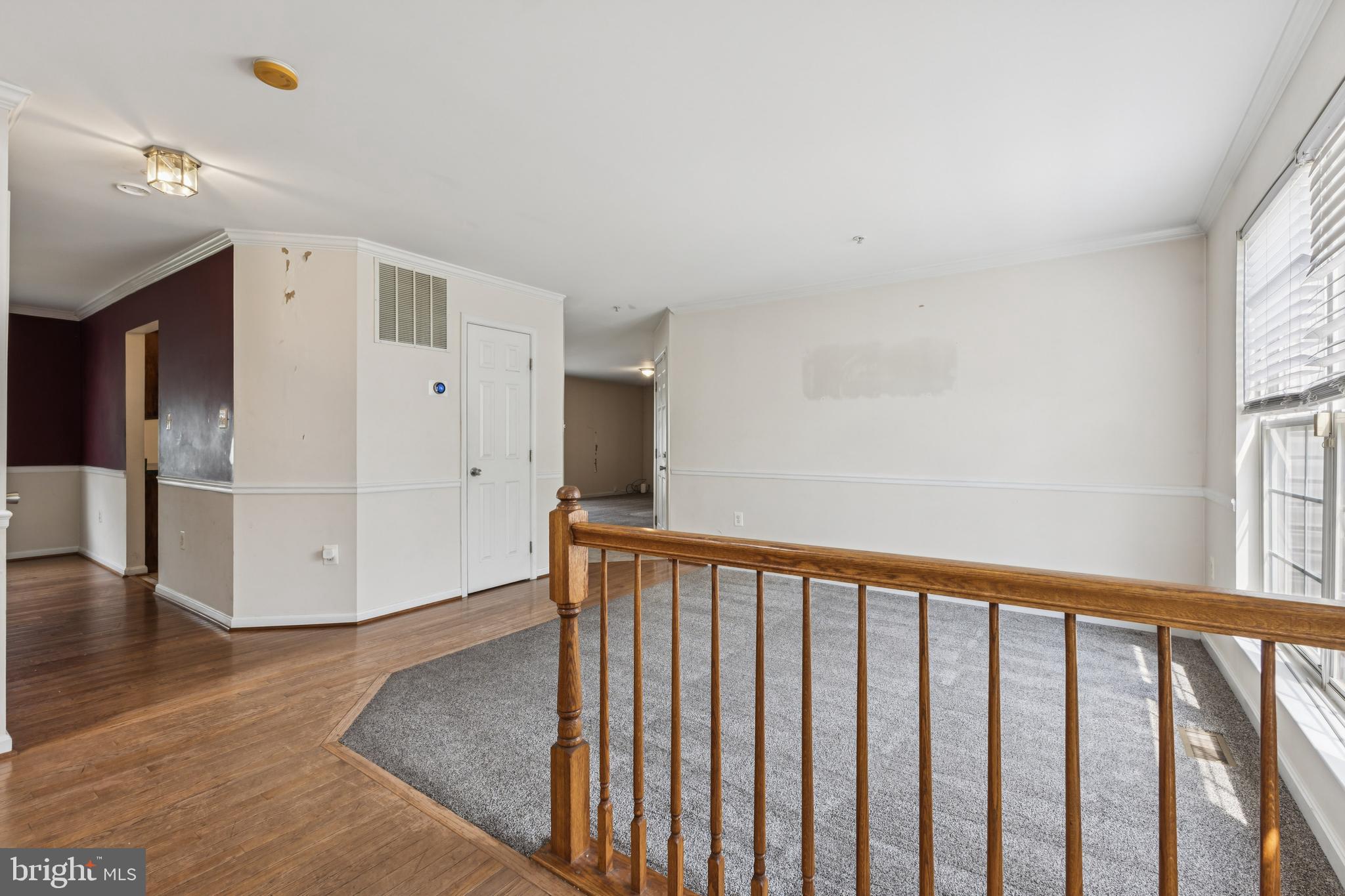 8305 Joan Place Clinton, MD 20735 - Photo 9 of 40 a view of a hallway with wooden floor and windows