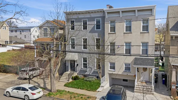 a front view of a building with glass windows and a table