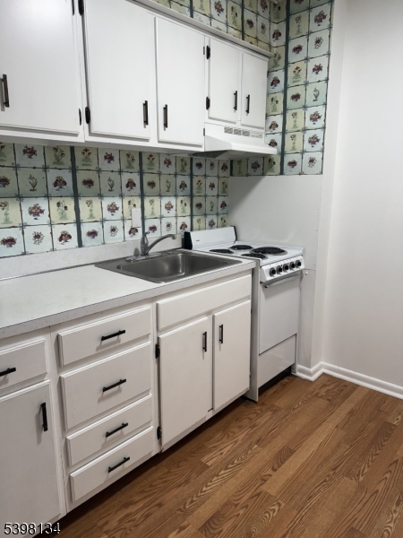 469 River Styx Road, Unit 29 Hopatcong, NJ 07843 - Photo 2 of 9 a kitchen with stainless steel appliances granite countertop a sink a stove and a wooden floors