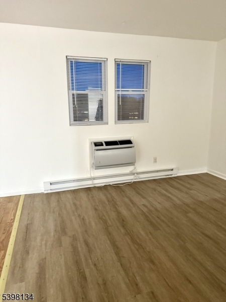 469 River Styx Road, Unit 29 Hopatcong, NJ 07843 - Photo 5 of 9 a view of an empty room with wooden floor and a window