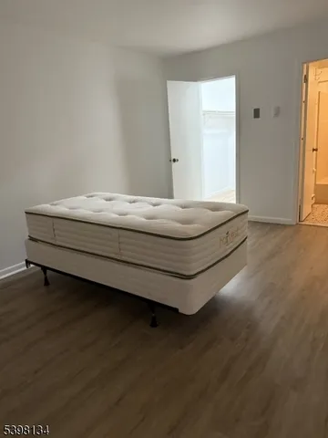 a room with wooden floor and window