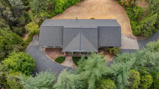 a kitchen with stainless steel appliances granite countertop wooden cabinets a granite counter tops and a window