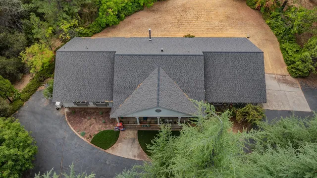 a kitchen with stainless steel appliances granite countertop a refrigerator and wooden cabinets