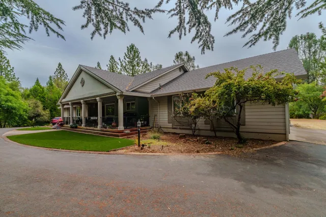 a front view of a house with garden and porch