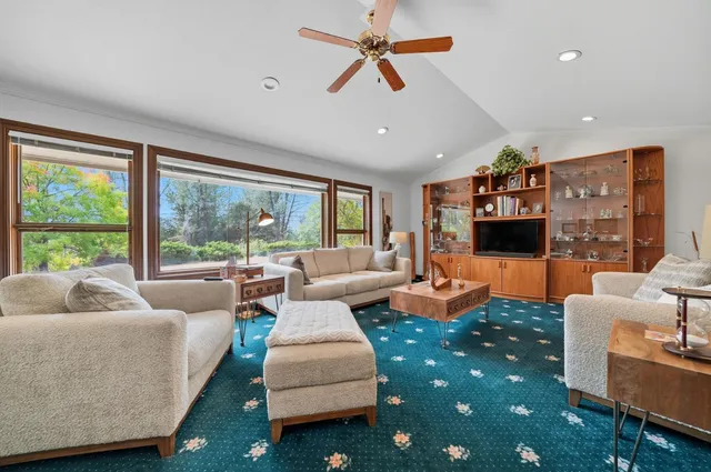 a spacious bedroom with a bed couch and a window