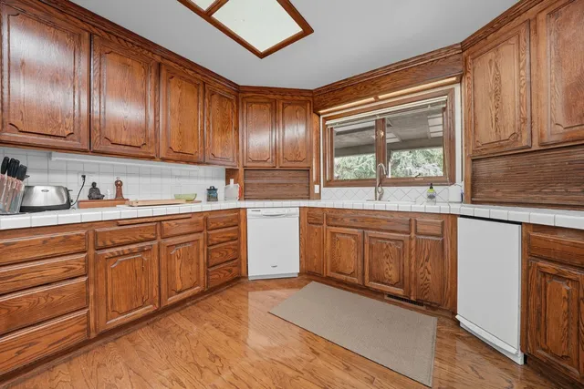 a spacious bathroom with a granite countertop sink and a mirror