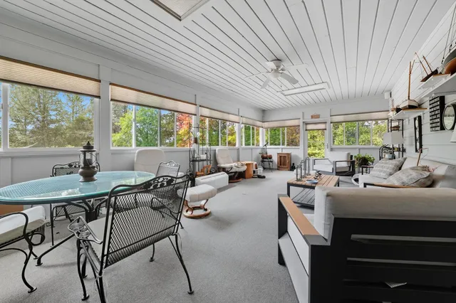 a bedroom with a bed and a dresser with rug