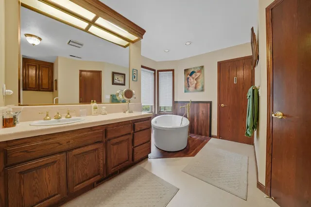 a living room with furniture fireplace and a large window