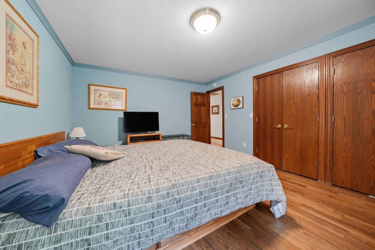 19491 East Clinton Road Jackson, CA 95642 - Photo 44 of 72 a bedroom with a bed and wooden floor