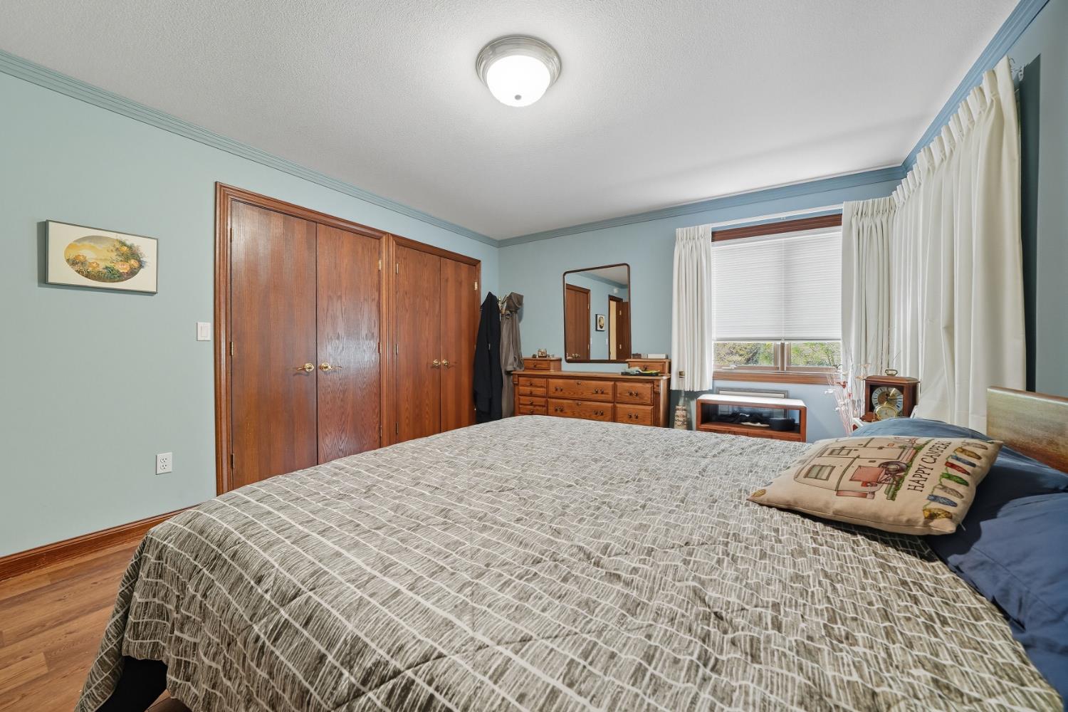 19491 East Clinton Road Jackson, CA 95642 - Photo 45 of 72 a bedroom with a bed and a dresser with rug