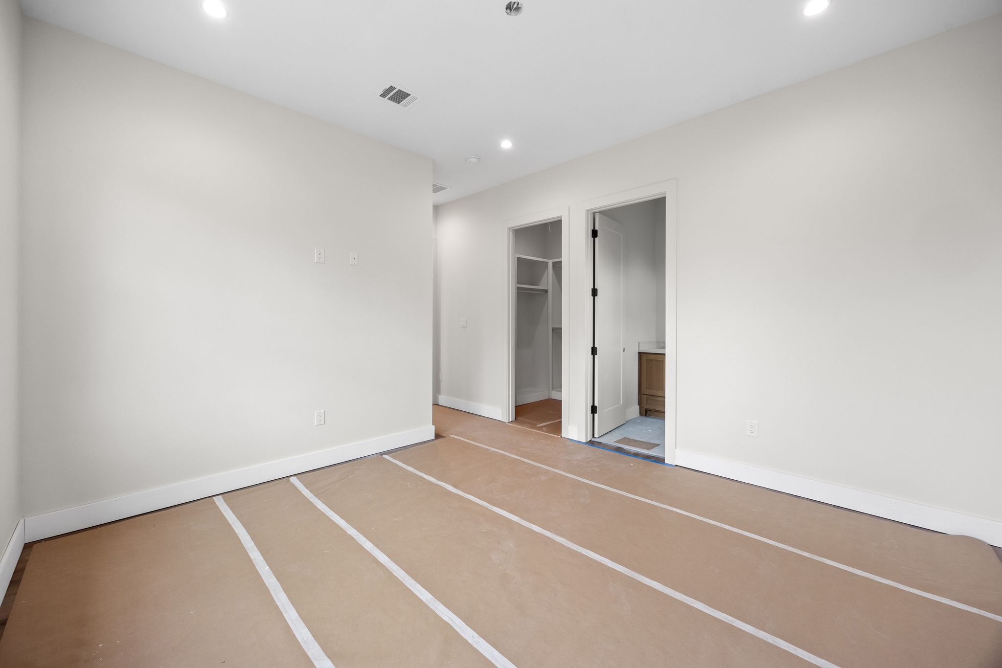903 Flint Ridge Trail Georgetown, TX 78628 - Photo 33 of 39 Spacious room featuring neutral painted walls, recessed lighting, white baseboards, and two doorways leading to additional areas