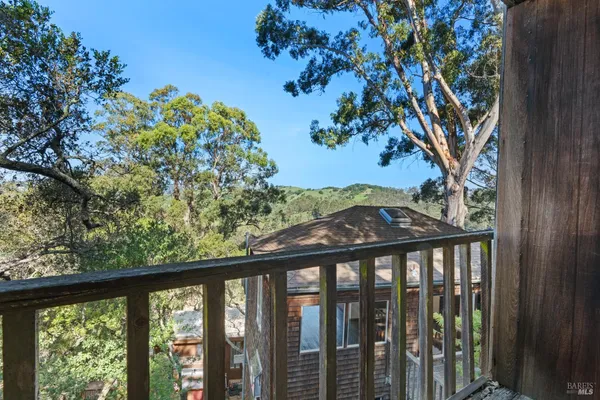 a view of a balcony with a tree