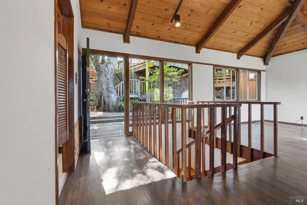 a view of a hallway with wooden floor