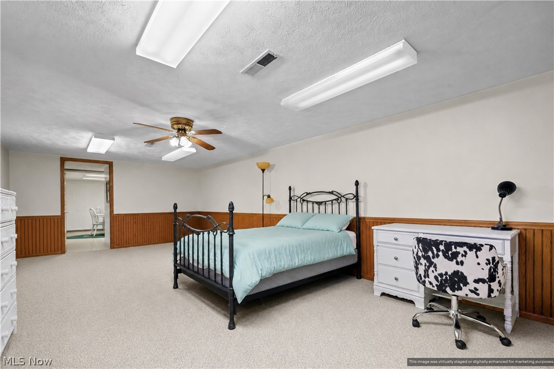 1835 Lynn Road Kent, OH 44240 - Photo 15 of 48 Spacious room with plush carpeting, wood-paneled wainscoting, and a ceiling fan with integrated lighting
