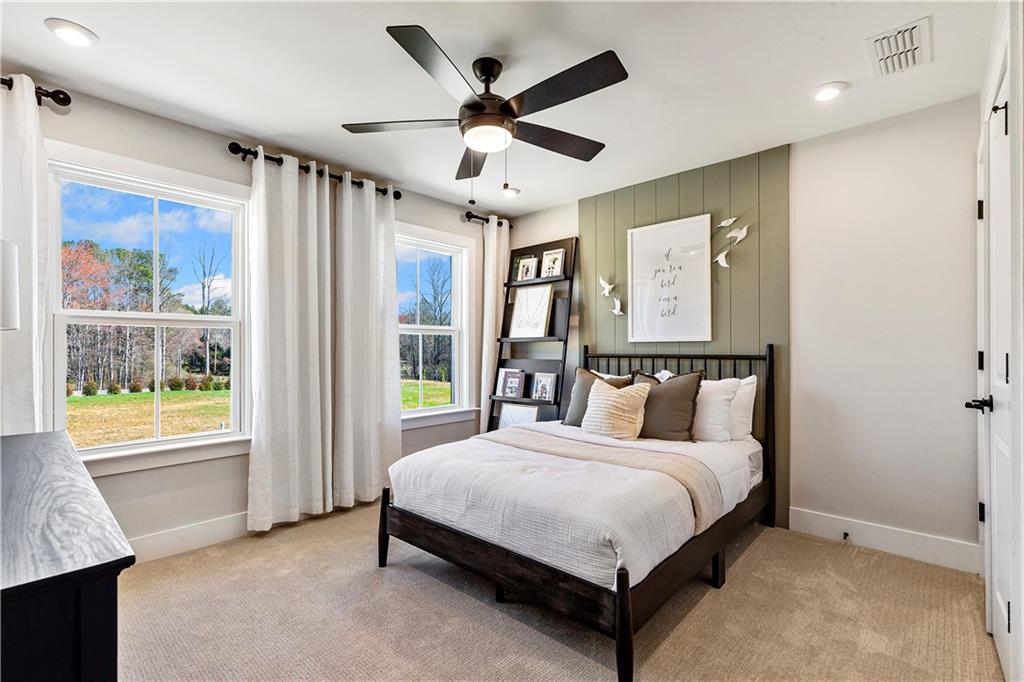239 Rockledge Bend Powder Springs, GA 30127 - Photo 13 of 14 a bedroom with a large bed and a chandelier fan