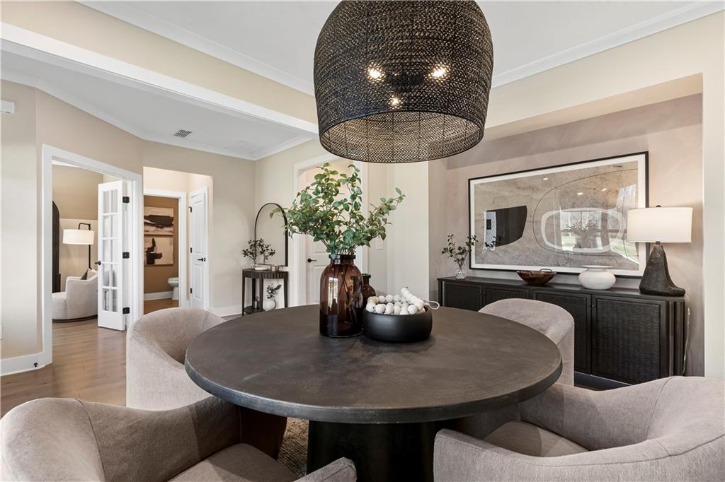239 Rockledge Bend Powder Springs, GA 30127 - Photo 5 of 14 a dining room with furniture a chandelier and wooden floor