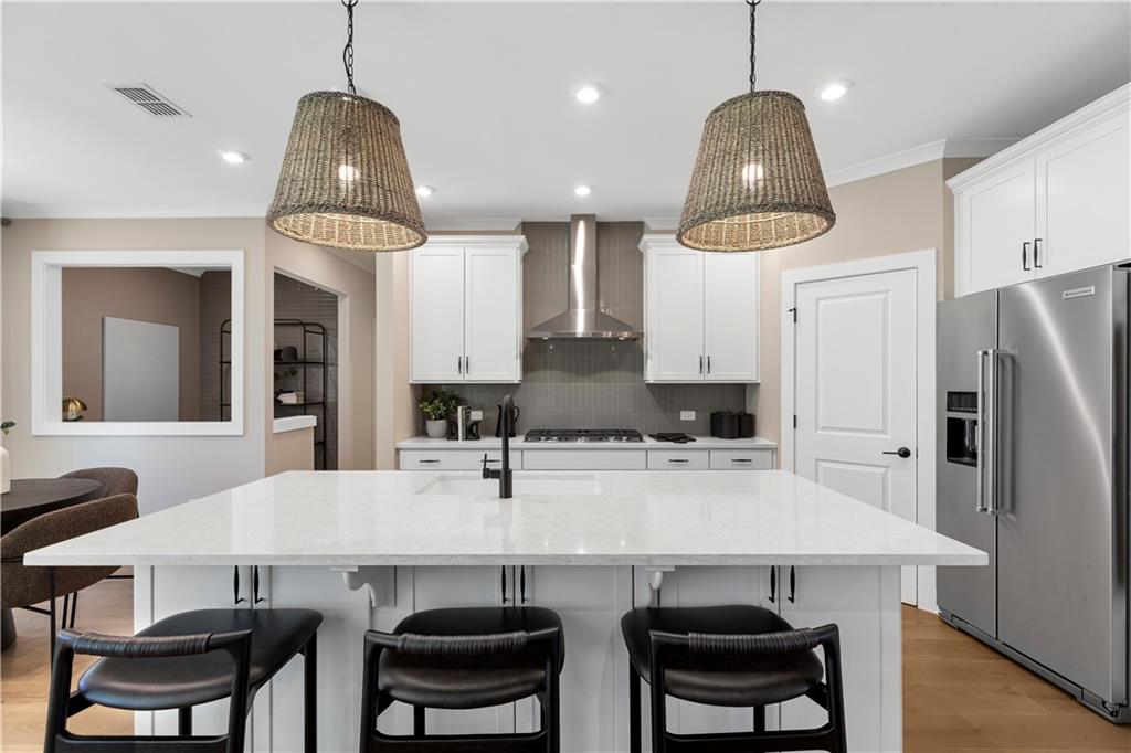 239 Rockledge Bend Powder Springs, GA 30127 - Photo 8 of 14 a kitchen with stainless steel appliances a dining table chairs and wooden floor
