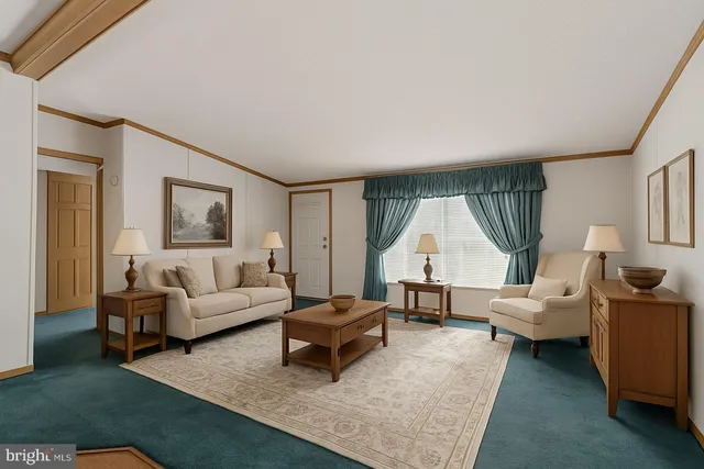 a dining room with furniture a chandelier and wooden floor