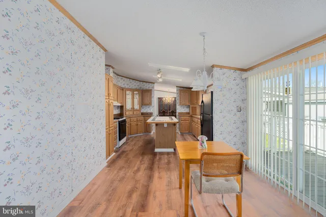 a view of an empty room with a window and fireplace