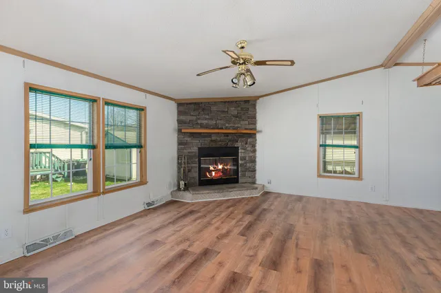a view of a livingroom with a fireplace and wooden floor