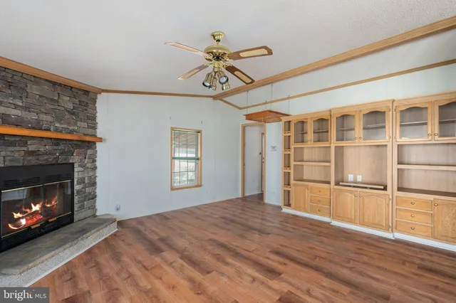 a view of a livingroom with a window and a ceiling fan