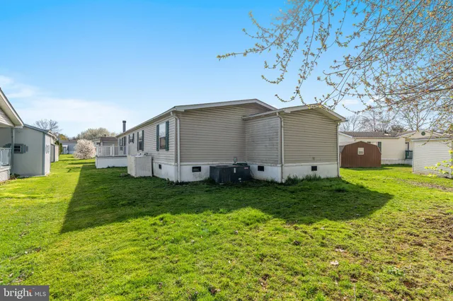 a view of a house with a yard and deck