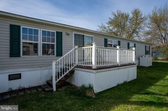 a view of a house with a yard and porch