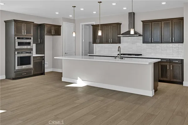 a large kitchen with stainless steel appliances granite countertop a stove a sink and a refrigerator