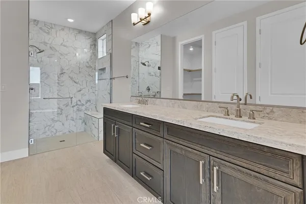a spacious bathroom with a granite countertop sink mirror and shower
