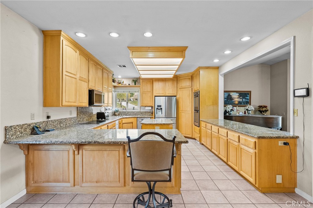 40647 Shallow Springs Road Leona Valley, CA 93551 - Photo 13 of 41 a kitchen with stainless steel appliances granite countertop sink stove refrigerator and cabinets