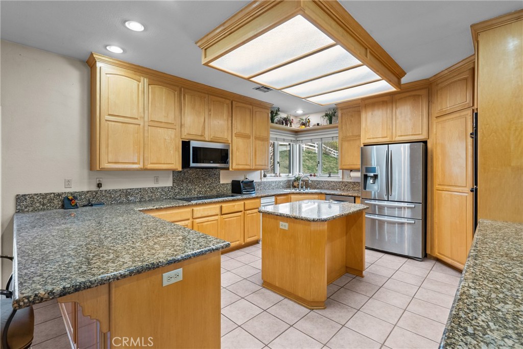 40647 Shallow Springs Road Leona Valley, CA 93551 - Photo 14 of 41 a kitchen with stainless steel appliances granite countertop a sink stove and refrigerator
