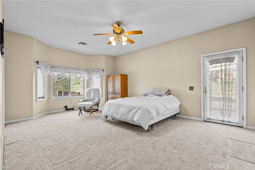 40647 Shallow Springs Road Leona Valley, CA 93551 - Photo 17 of 41 a spacious bedroom with a bed and a large window