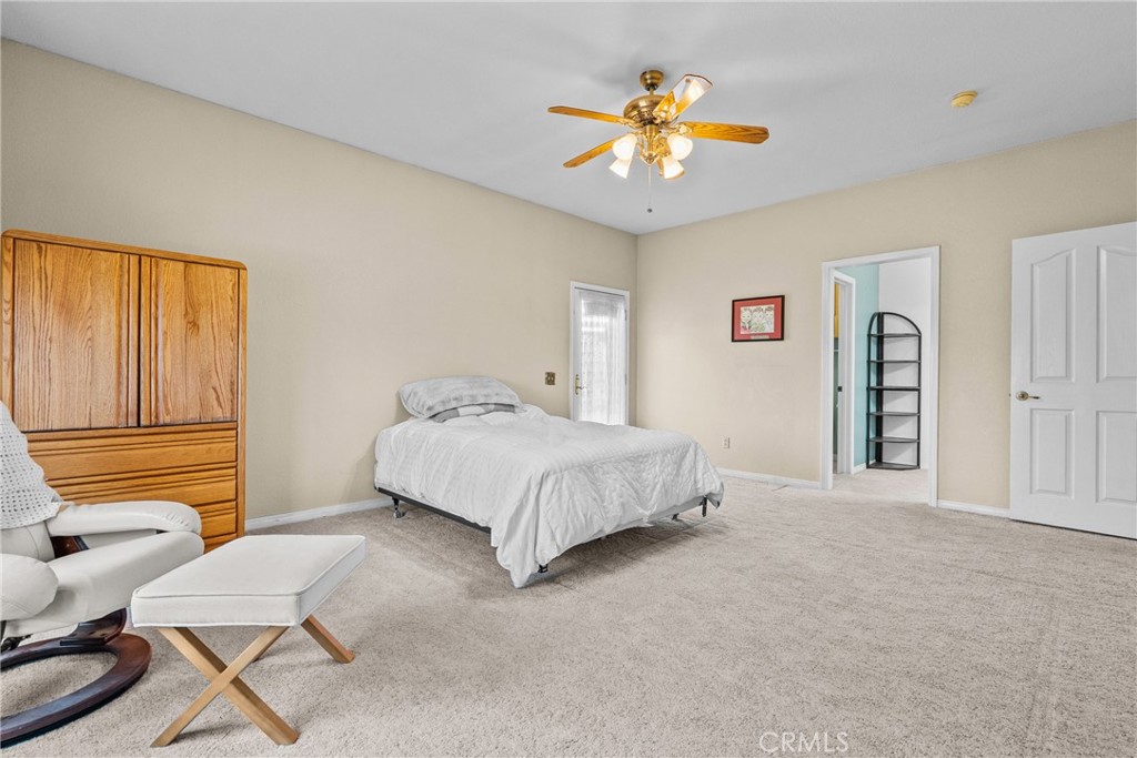 40647 Shallow Springs Road Leona Valley, CA 93551 - Photo 18 of 41 a bedroom with a bed and a chandelier