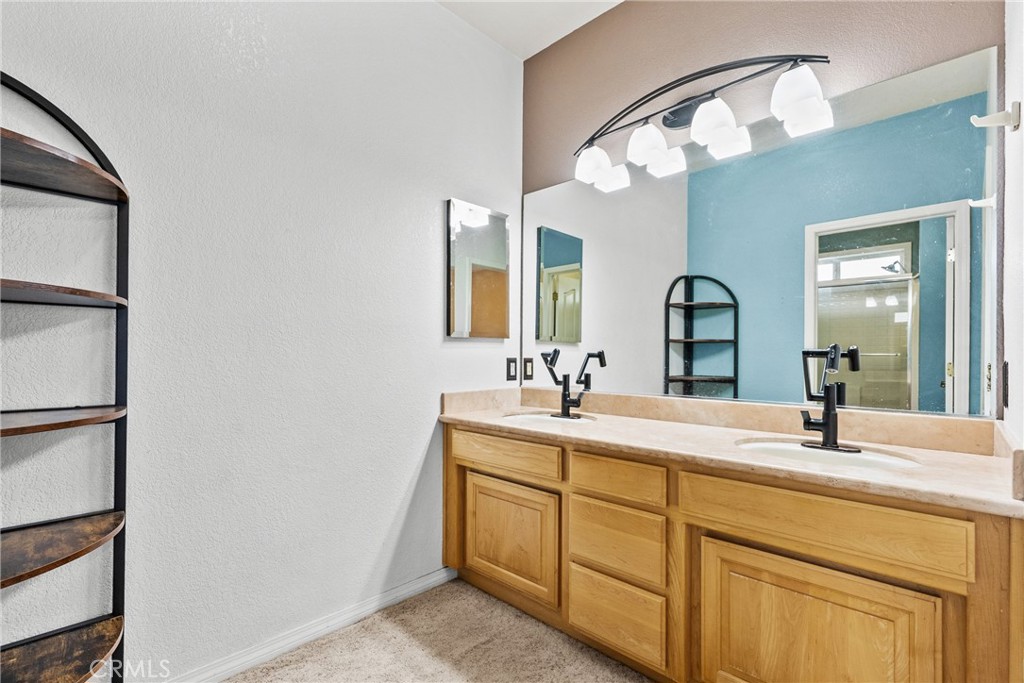 40647 Shallow Springs Road Leona Valley, CA 93551 - Photo 19 of 41 a bathroom with a double vanity sink and a mirror