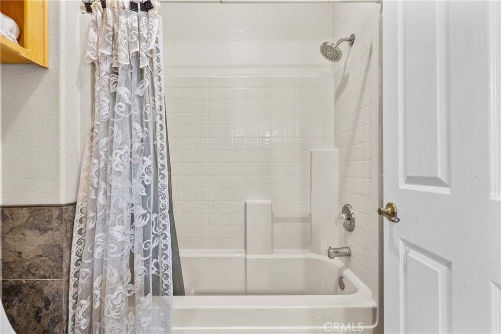40647 Shallow Springs Road Leona Valley, CA 93551 - Photo 31 of 41 a bathroom with a shower curtain and a bath tub