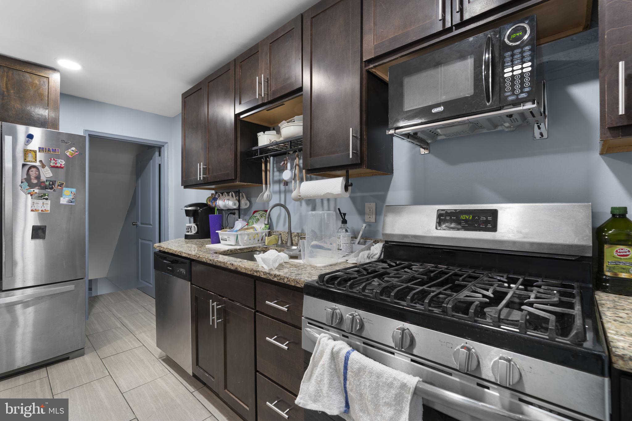 514 Umbra Street Baltimore, MD 21224 - Photo 15 of 37 a kitchen with a stove and a refrigerator