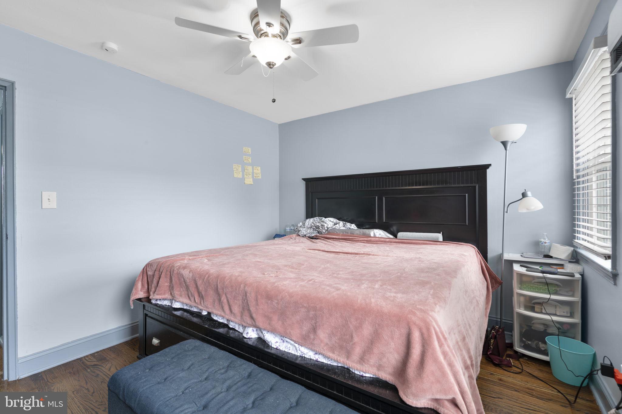 514 Umbra Street Baltimore, MD 21224 - Photo 18 of 37 a bedroom with a bed and a chandelier