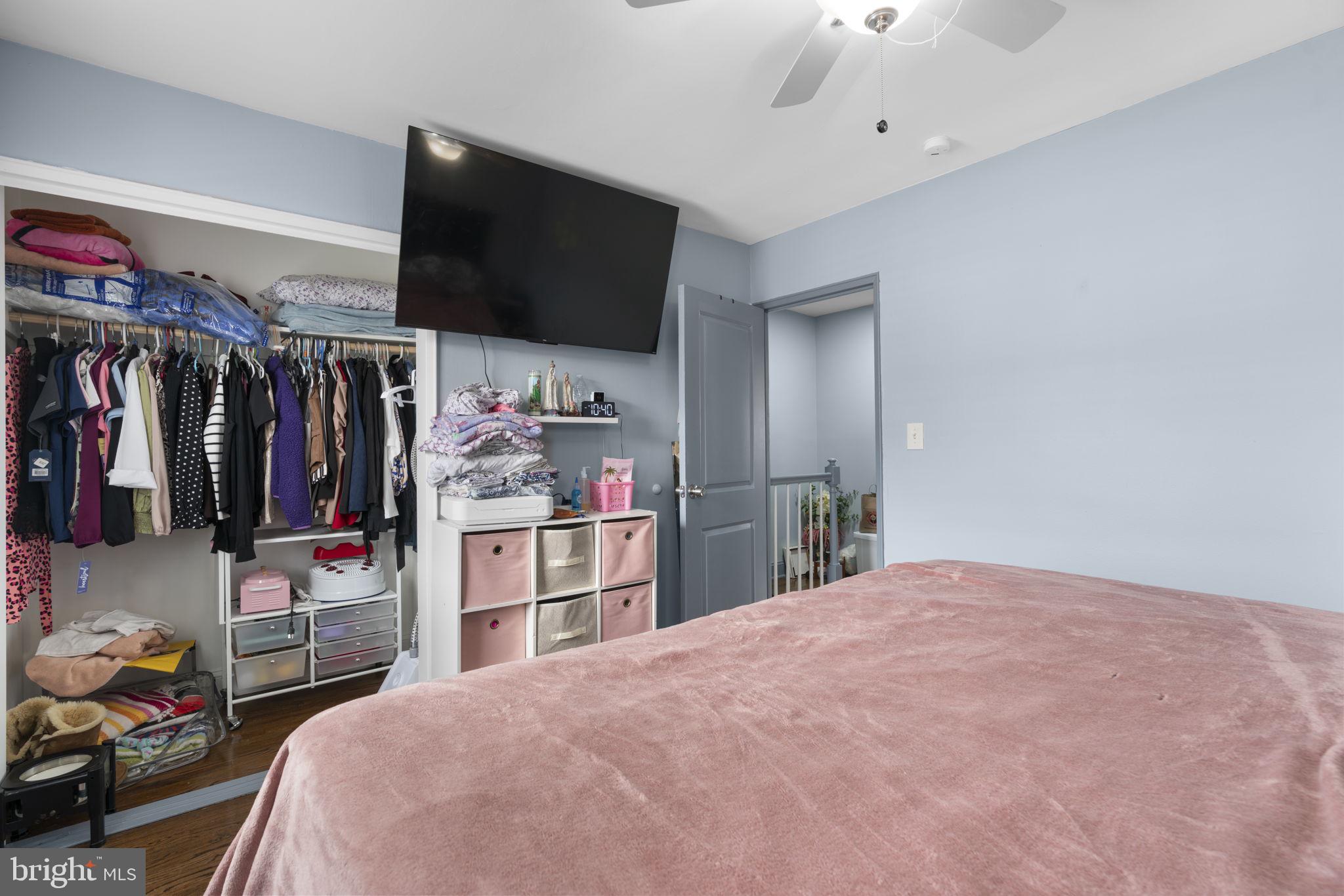 514 Umbra Street Baltimore, MD 21224 - Photo 19 of 37 a bedroom with a bed and a flat screen tv