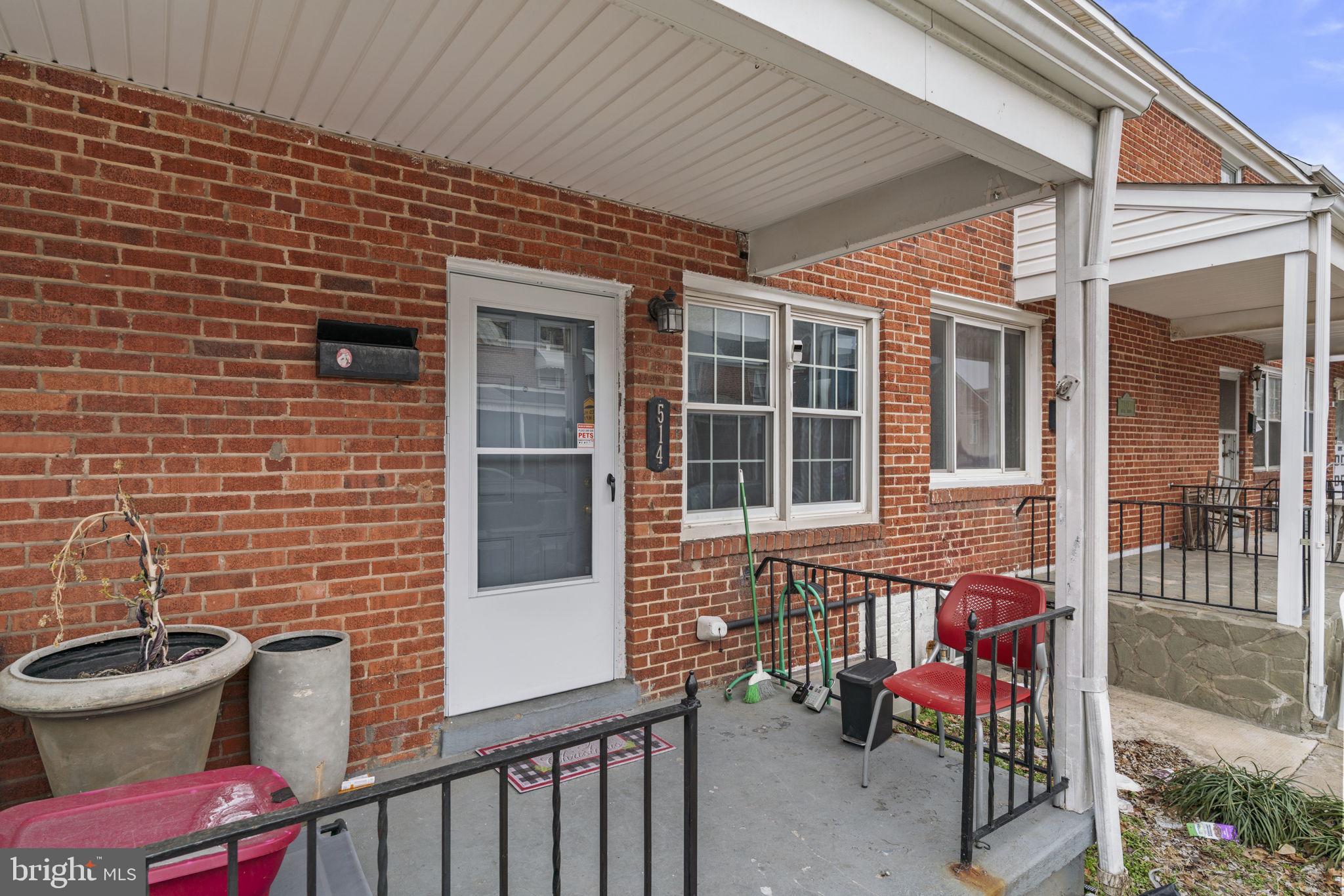 514 Umbra Street Baltimore, MD 21224 - Photo 5 of 37 a view of a door with a chairs and table in the patio