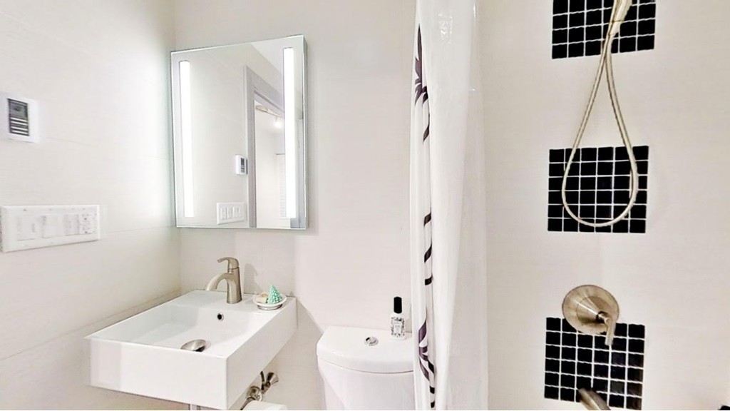 1206 Greendale Avenue, Unit 201 Needham, MA 02492 - Photo 12 of 26 a bathroom with a sink and a mirror