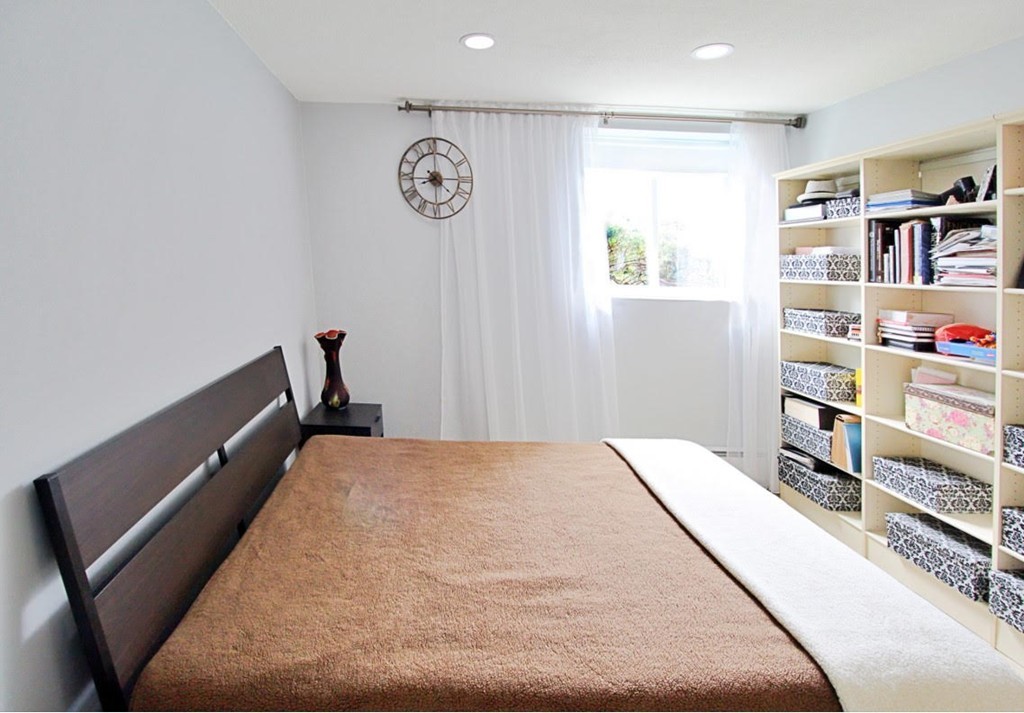 1206 Greendale Avenue, Unit 201 Needham, MA 02492 - Photo 13 of 26 a bed room with a bed and a book shelf
