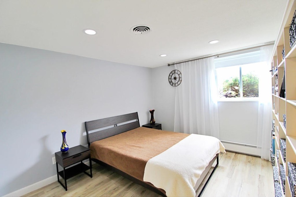 1206 Greendale Avenue, Unit 201 Needham, MA 02492 - Photo 14 of 26 a bedroom with a bed and a window