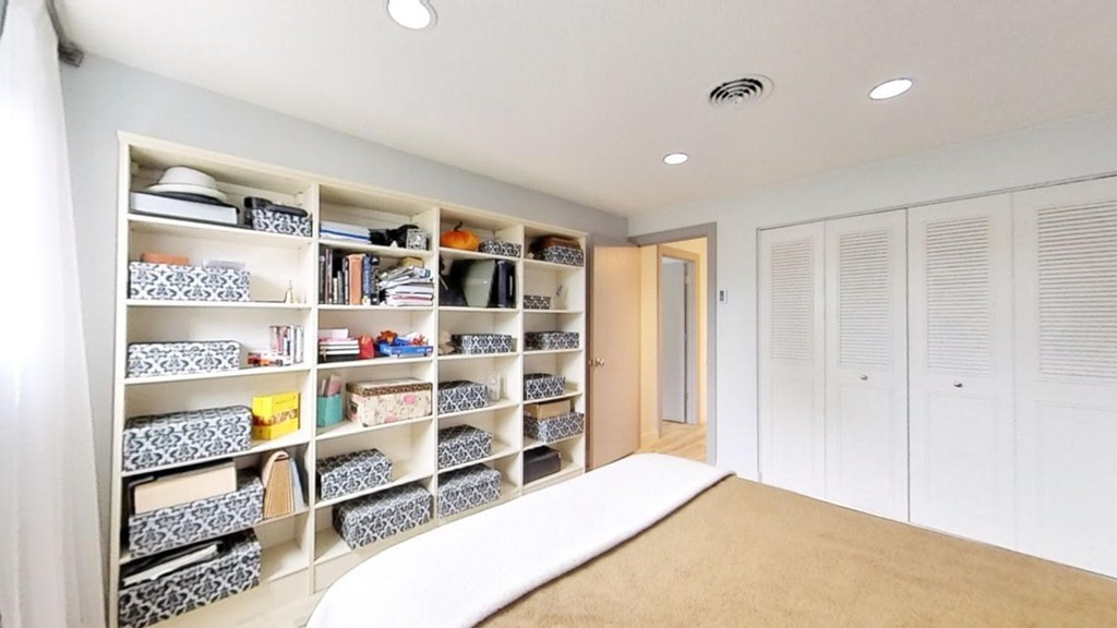 1206 Greendale Avenue, Unit 201 Needham, MA 02492 - Photo 15 of 26 a bedroom with a bed and closet
